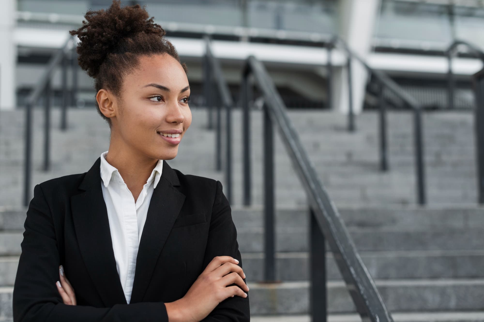 Woman in business clothing smiling and looking to her left