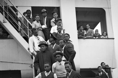 Jamaican people standing on staircase