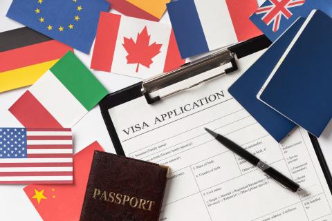 Visa application form with passport and flags of different countries